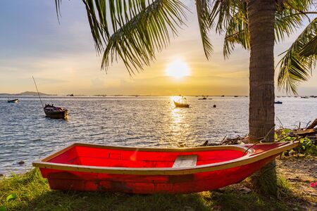 Sunset sea view with boats and palm trees in Siracha Thailandの写真素材