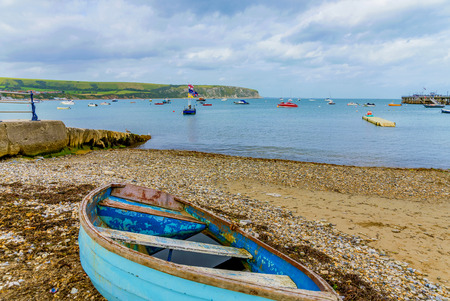 SWANAGE, UNITED KINGDOM - SEPTEMBER 07: This is and abandoned boat washed up on the shore of Swanage beach on September 07, 2017 in Swanageのeditorial素材