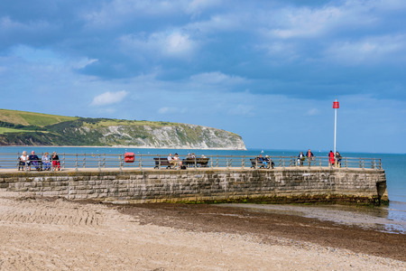 SWANAGE, UNITED KINGDOM - SEPTEMBER 07: This is a view of a waterfront pier with people sitting and relaxing on September 07, 2017 in Swanageのeditorial素材