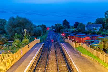 CORFE, UNITED KINGDOM - SEPTEMBER 08: Train tracks and train yard at night in Corfe Castle railway station on September 08, 2017 in Corfeのeditorial素材