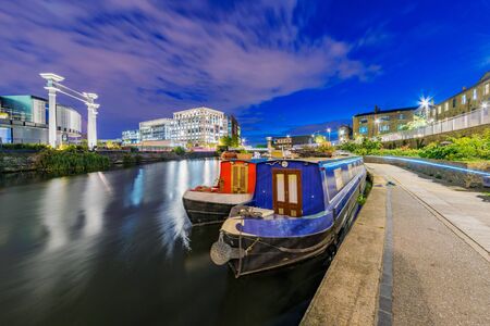 LONDON, UNITED KINGDOM - SEPTEMBER 23: This is a night view of Regents Canal with traditional English boats in Kings Cross on September 23, 2017 in Londonのeditorial素材