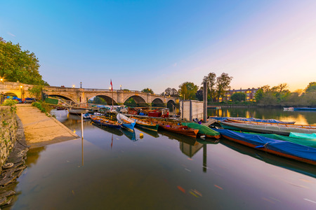 Boats and richmond bridge at dusk in Londonの写真素材