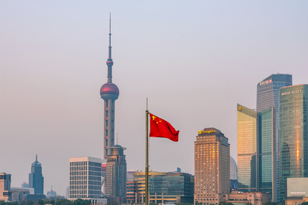 SHANGHAI, CHINA - MARCH 11: View of Pudong financial district architecture with Chinese flag on March 11, 2016 in Shanghaiのeditorial素材