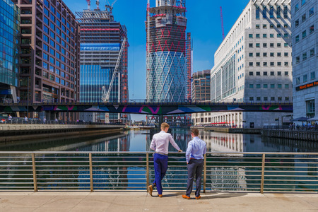 LONDON, UNITED KINGDOM - APRIL 20: Office workers talking and enjoying the view on a sunny day in...