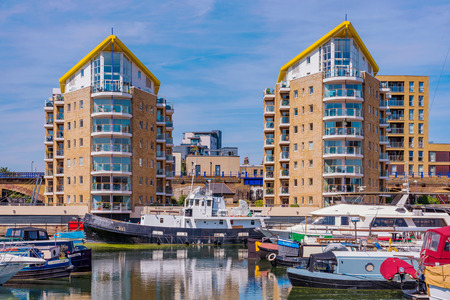 LONDON, UNITED KINGDOM - JUNE 06: This is a view of waterfront apartment buildings and boats in Limehouse Basin, a famous marina along the Regent's Canal on June 06, 2018 in Londonのeditorial素材