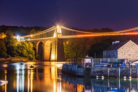 ANGLESEY, UNITED KINGDOM - SEPTEMBER 06: Night view of the famous Menai Suspension bridge alog the Menai Straits on September 06, 2018 in Angleseyのeditorial素材
