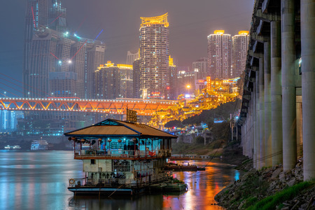 CHONGQING, CHINA - SEPTEMBER 16: This is a night view of a boat along the JIaling river near Qiansimen bridge and Hongya cave in the downtown area on September 16, 2018 in Chongqingのeditorial素材