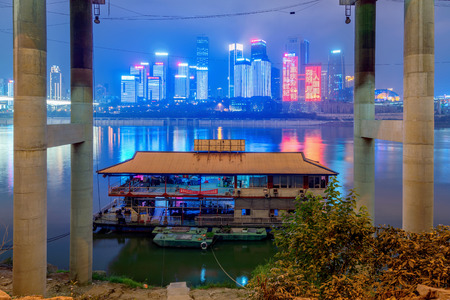 CHONGQING, CHINA - SEPTEMBER 16: View of a bridge with a boat and Chongqing city buildings on the Yangtze River in September 16, 2018 in Chongqingのeditorial素材