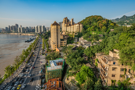 CHONGQING, CHINA - SEPTEMBER 21: View of Nanbin Road city buildings and mountains on September 21, 2018 in Chongqingのeditorial素材