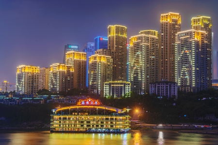 CHONGQING, CHINA - SEPTEMBER 23: Night view of modern high rise apartment buildings along the Yangtze river on September 23, 2018 in Chongqingのeditorial素材