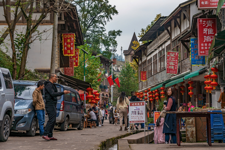 PENGZHOU, CHINA - OCTOBER 06: View of a street with restaurants and shops in Bailu Town, a famous travel destination in Sichuan on October 06, 2018 in Pengzhouのeditorial素材