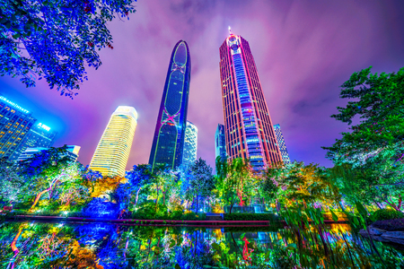 GUANGZHOU, CHINA - OCTOBER 18: Night view of high rise city buildings along a lake in Zhujiang Park in the downtown area on October 18, 2018 in Guangzhouのeditorial素材