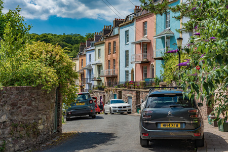 BRISTOL, UNITED KINGDOM - JULY 03: This is a residential street with colourful houses and trees on...