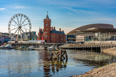 CARDIFF, UNITED KINGDOM - JULY 04: View of the Cardiff Bay waterfront area with the Pierhead landmark building and ferris wheel on July 04, 2019 in Cardiffのeditorial素材