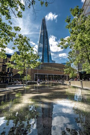 LONDON, UNITED KINGDOM - AUGUST 22: Low perspective view of The Shard skyscraper building, a famous landmark in the City of London on August 22, 2019 in London