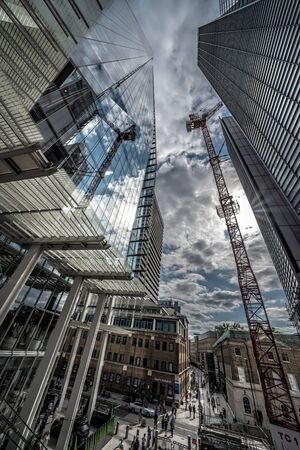 LONDON, UNITED KINGDOM - AUGUST 22: Low angle view of The Shard and modern office buildings in the City of London financial district  on August 22, 2019 in Londonのeditorial素材