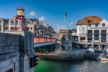 WEYMOUTH, UNITED KINGDOM - AUGUST 30: Traditional bridge and historic buildings at Weymouth Harbour, a popular travel destination on August 30, 2019 in Weymouthのeditorial素材