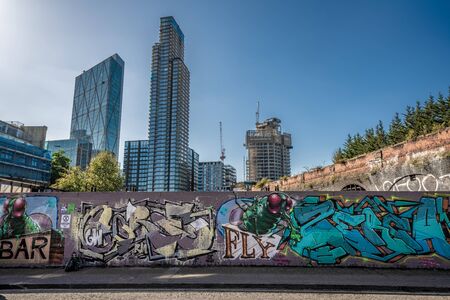 LONDON, UNITED KINGDOM - SEPTEMBER 18: Graffiti covered wall in Shoreditch with financial district...