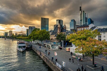 FRANKFURT, GERMANY - SEPTEMBER 25: View of the riverside promenade and city buildings in Frankfurt during sunset on September 25, 2019 in Frankfurtのeditorial素材