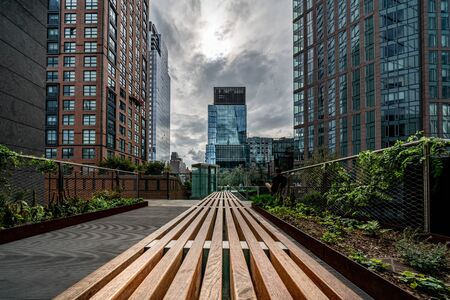 NEW YORK, USA - OCTOBER 07: View of modern buildigs and bench at the High Line Park, a popular travel destination on October 07, 2019 in New Yorkのeditorial素材