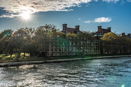 NEW YORK, USA - OCTOBER 10: View of historic architecture with sunlight shining through at Ellis Island on October 10, 2019 in New Yorkのeditorial素材