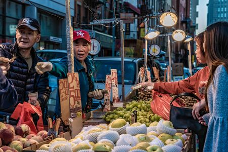 NEW YORK, USA - OCTOBER 14: Street scene of local street vendors selling fruits and vegetables in Chinatown on October 14, 2019 in New Yorkのeditorial素材