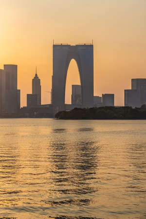 SUZHOU, CHINA- NOVEMBER 05: View of the Gate to the East and waterfront city buildings during sunset on Jinji Lake on November 05, 2019 in Suzhouのeditorial素材