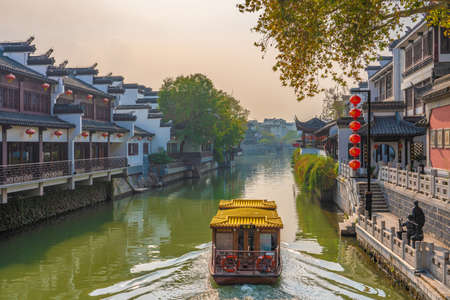 NANJING, CHINA - NOVEMBER 08: Scenic view of a boat on the Qinhuai River in the Fuzimiao historic district during sunset on November 08, 2019 in Nanjingのeditorial素材