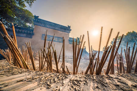 NANJING, CHINA - NOVEMBER 08: Incense sticks burning with the sunset shining through at Jiming buddhist temple on November 08, 2019 in Nanjingのeditorial素材