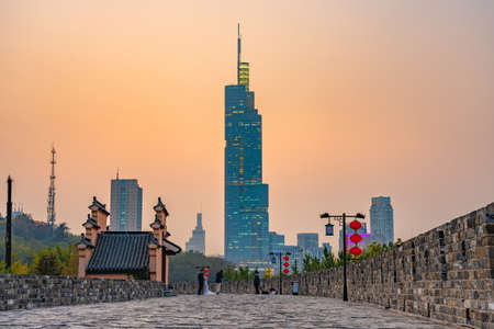 NANJING, CHINA - NOVEMBER 08: This is a view of the ancient city wall and the Zifeng Tower skyscraper during sunset on November 08, 2019 in Nanjingのeditorial素材
