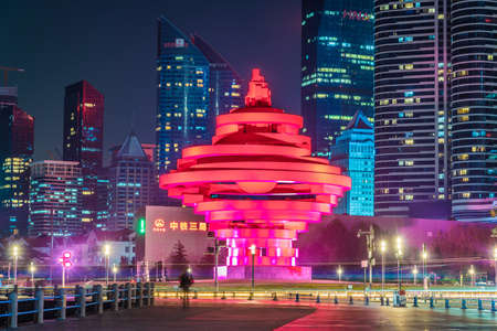 QINGDAO, CHINA - NOVEMBER 13: Night view of the May Fourth Square monument and financial district city buildings on November 13, 2019 in Qingdaoのeditorial素材