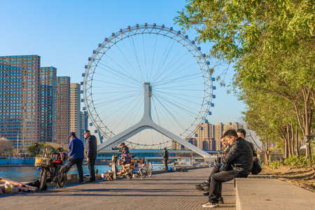 TIANJIN, CHINA - NOVEMBER 19: Riverside view of the Tianjin Eye, a famous landmark in the downtown area along the Hai River on November 19, 2019 in Tianjinのeditorial素材