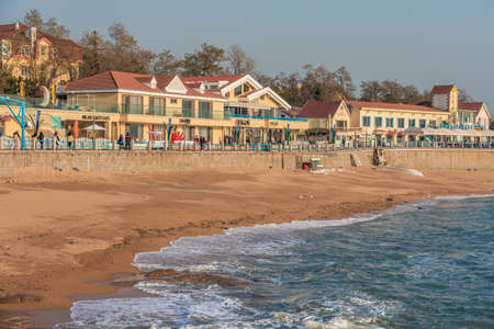 QINGDAO, CHINA - NOVEMBER 15: View of a local beach with waterfront buildings and cafes at Badaguan Scenic area on November 15, 2019 in Qingdaoのeditorial素材