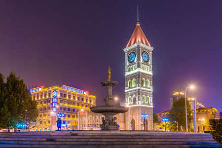 TIANJIN, CHINA - NOVEMBER 17: Night view of an Italian style clock tower and fountain in the city center on November 17, 2019 in Tianjinのeditorial素材