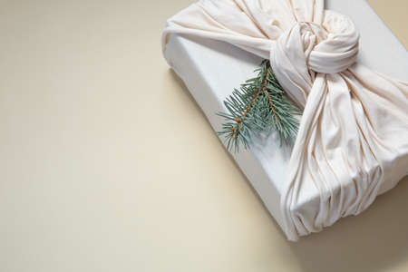 Zero waste gift wrapping traditional Japanese furoshiki style. Sustainable design concept. Christmas presentの写真素材