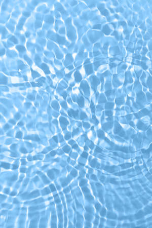 Fresh water background. Bright blue pattern with natural rippled water texture and bubbles. Top view...