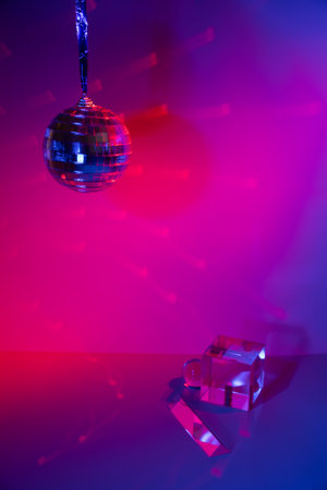 Glass prisms and a ball in neon light. Disco mirror ball. Blue, pink, purpleの写真素材