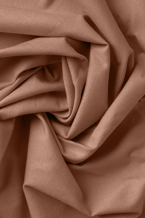 Textured folds of linen fabric in natural brown color. Textile background, top view, copy spaceの写真素材