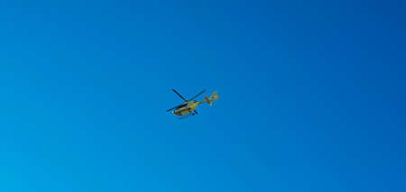 Helicopter in flight at sunset in summerの写真素材