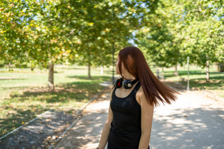Young woman with photo camera in parkの写真素材