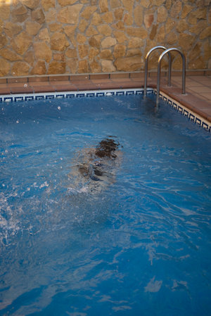 Young girl swimming underwater in the poolの写真素材
