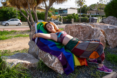 Wearing the Rainbow: Young Woman Displaying the LGTBI Flagの写真素材