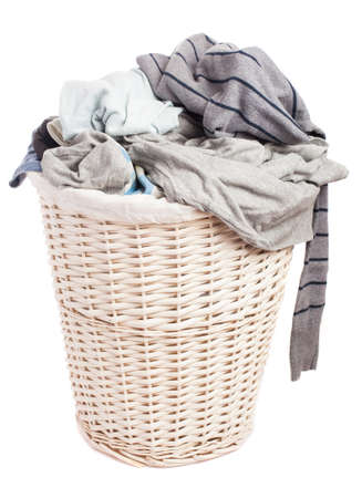 dirty clothes in a basket on a white backgroundの写真素材