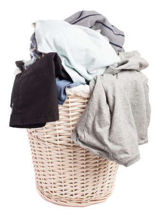 dirty clothes in a basket on a white backgroundの写真素材