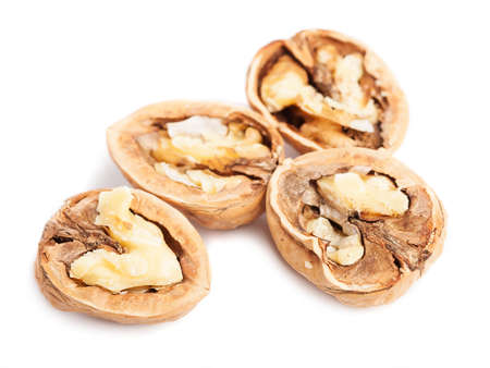 some walnuts opened on a white background
