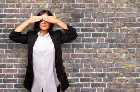 latin business woman covering her eyesの写真素材