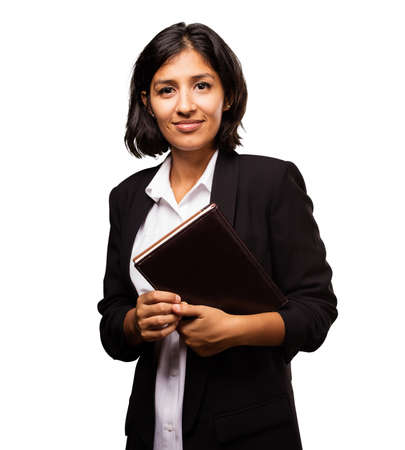 latin business woman holding a notebookの写真素材