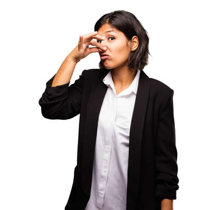 latin business woman smelling badの写真素材