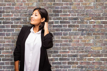 latin business woman touching her hairの写真素材