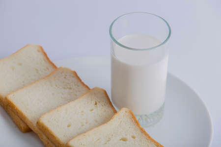 Closeup bread milk glass in a plateの写真素材